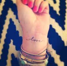 35 Spectacular One Word Tattoo Designs You Will Love To Get Inked Love Wrist Tattoo Tattoos Feminine Tattoos