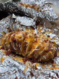 These baked potatoes are covered in a hamburger gravy, and topped with shredded cheese. Cheese Bacon Hasselback Potatoes From Michigan To The Table