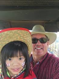 Grace Wisser and Matthew Wismer celebrating her 8th birthday steering a 125  hp tractor all by herself as she pulls her family and friends in the wagons  behind, during her recent birthday