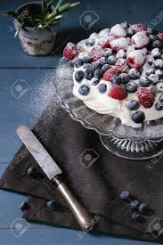Meringue should be on the sweet side, with a crisp texture that will instantly melt in your mouth. Vintage Cake Stand With Meringue Dessert Pavlova With Sugar Powder Fresh Blackberries And Raspberries Over Blue Wooden Table With Old Knife Textile Napkin And Snowdrops Flowers Dark Rustik Style Stock Photo Picture