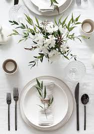 Lay a placemat at each seat, keeping the edge of the placemat one inch from the edge of the table. 5 Tips To Set A Simple And Modern Tablescape Homey Oh My Wedding Table Settings Minimal Table Setting Modern Tablescape