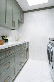 • create a schedule for doing laundry. Green Shaker Laundry Room Cabinets With White And Gray Marble Picket Tiles Transitional Laundry Room
