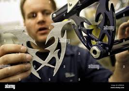 ADVANCE FOR WEEKEND JAN. 14, 15 ** Bill Lasher Jr. who started Lasher  Sports LLC in March, shows a before and after custom metal cutout in his  shop in Anchorage, Alaska Dec.