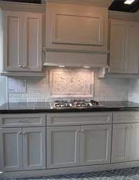 In this kitchen, where black meets white, colorful glass mosaic backsplash adds a different atmosphere. 15 Best Gray Cabinets Black Counter Ideas Gray Cabinets Black Counter Kitchen Redo Kitchen Remodel