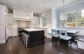 Kitchen cabinets are painted in dark steel blue, while the two small overhead cabinets are painted in white to blend into the white subway tiles on the walls. Dark Cabinets With White Walls Novocom Top