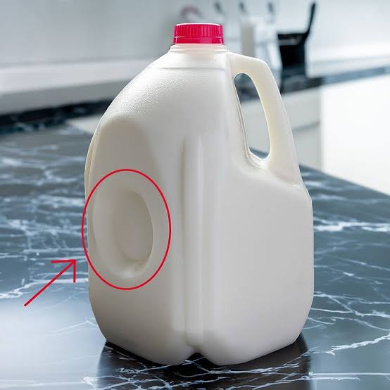 Here's Why There's a Dent on the Side of Your Plastic Milk Jug