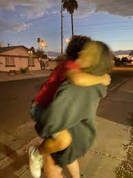 Two young women laughing and walking enjoying carefree vacation lifestyle. Blurry Photo Of My Friends Hugging Goodbye Best Friend Hug Friends Hugging Best Friends Aesthetic