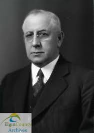 Photograph of students boarding a Schweitzer School Bus at the corner of  Pearl and Elysian in front of the St. Thomas Collegiate Institute gym in  May 1947. Schweitzer Motors, run by Albert