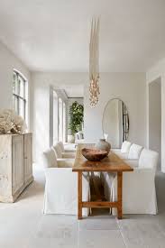 When you have a narrow space, go for a long and slim, rectangular dining room table instead of a bulky one. University House With A Belgian Minimal Aesthetic Modern Dining Room White Dining Room Narrow Dining Tables