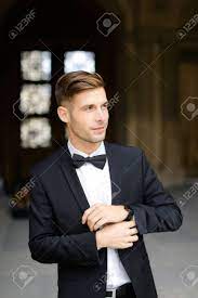 Although i was wearing black and i am an architect i didn't have a spontaneous answer, so i responded: Young Man Standing And Posing Wearing Black Suit And Bow Tie Stock Photo Picture And Royalty Free Image Image 144118998