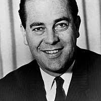 A black and white photo of a man in a suit. Great Depression and World War  Two FSA/OWI Photograph