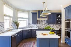 Dark blue kitchen cabinets with brass hardware. Remodeling Trends