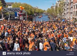 Carnival, dancing, singing and as much fun as you can ever imagine take place on the king's day (dutch: Amsterdam Koningsdag Auf Der Torensluis Brucke Auf Die Singel Gracht Mit Einem Feiernden Publikum Auf Einer Sonnigen Konigstag Stockfotografie Alamy