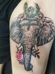 Elephant And Flowers Tattoo Elephant Tattoos Elephant Tattoo Design Gem Tattoo
