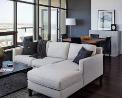 It helps to give accent and it increases aesthetics too in your living room. Stylish Modern Living Room With Window Wall Neutral Sectional Charcoal Gray Accent Wall Panel And Connected Dining Room Hgtv
