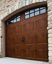 A Gorgeous Wood Garage With Decorative Windows And A Stone Siding Surround Click To See The Average Garage Door Design Garage Door Styles Brick Exterior House