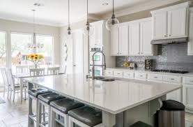 The kitchen, dining room and living room are beautifully distinguished by placing large jute chenille rugs in the center of each area while wood is used as a common material in the three spaces to merge them cohesively. Dining Room Design Ideas With Images Housing News