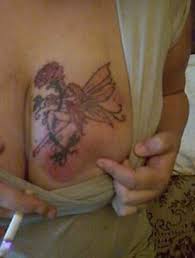 Fairy tattoo designs go very well with colorful flowers that can be rendered in bright colors to contrast. Fairy Tattoo With Flower