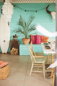 The refurbished space features white walls and concrete floors with warming furniture motifs and pastel colors. Fun Tropical Style And Beach Decor Chic Beach House Beach House Interior Design Beach House Decor