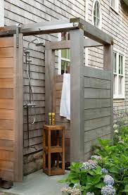 A Gray Teak Outdoor Shower Boasts A Gray Teak Door On Rails And A Polished Nickel Shower Kit A Cottage Outdoor Outdoor Shower Enclosure Outdoor Bathroom Design