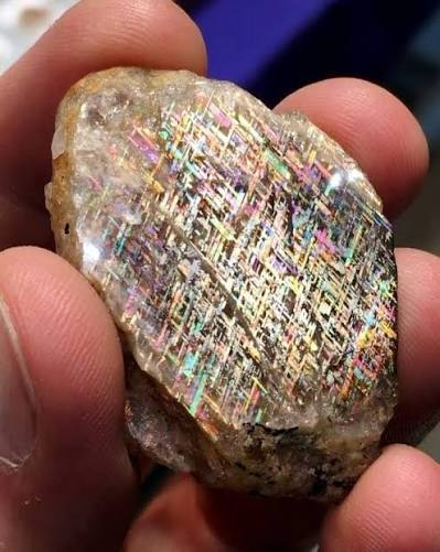At first glance, this looks like a piece of futuristic technology trapped  inside crystal—but it's actually a real gemstone called Rainbow Lattice  Sunstone. Found only in a small, remote area of Australia's