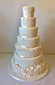 A Beautiful Seven Tier Wedding Cake Styled With Delicate Lace And Ruffle Designs For An Elega Beautiful Wedding Cakes Simple Wedding Cake Elegant Wedding Cakes