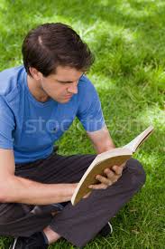 Check spelling or type a new query. Young Serious Man Sitting Cross Legged On The Grass In A Park While Reading A Book Stock Photo C Wavebreak Media 2646338 Stockfresh
