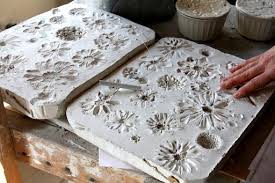 To press flowers, pick the flowers on a hot, dry day to prevent molding, and find a heavy book to press your flowers in, such as an encyclopedia, dictionary, or phone book. Technique Of Frances Palmer Pressing Flowers Into Wet Slabs Of Clay Clay Ceramic Artists Clay Pottery