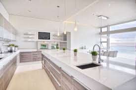 This gorgeous modern kitchen echoes the serene beauty of a white sandy beach, punctuated by the stunning ocean view just beyond the room's enormous windows. Our Favorite Modern Kitchens From Top Designers White Modern Kitchen Modern Kitchen Design Modern Kitchen