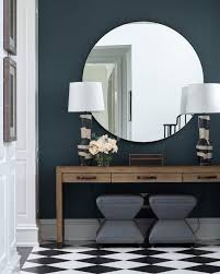 A coppery round mirror in a pink bedroom with a worn floor. Decorating Walls With Mirrors Professional Tips To Know Decoholic