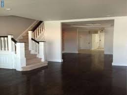 The dark finishes of the floors and the island's wood top add warmth to the creamy white kitchen. Dark Wood Floor Cream Walls White Doors Home Dream House Cream Walls
