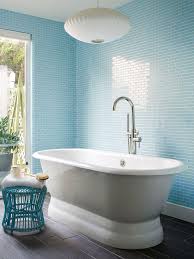 Walls Of Sky Blue Glass Subway Tiles Give Off The Reflective Qualities Of Water In This Simple Bathr Light Blue Bathroom Bathroom Color Schemes Bathroom Colors