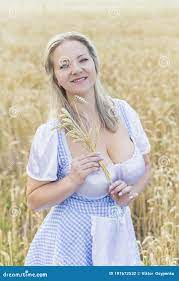 Blonde with Big Breasts Holds Spikelets in a Field with Wheat Stock Photo -  Image of agriculture, beauty: 197672532