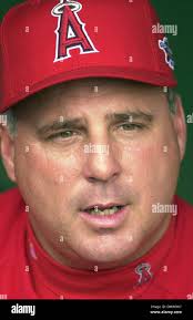 Anaheim Angels manager Mike Scioscia, left, has words with home plate  umpire Wally Bell, right, as third base umpire Chris Guccione looks