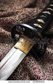 Close Up Japanese Sword Katana On Satin With Warm Fall Colors Soft Focus In The Background Over Light Japanese Sword Japanese Sword