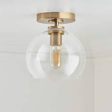 Now, flush mount lighting can be found almost anywhere and these ceiling and wall fixtures complement a variety of residential and commercial settings. Arren Brass Flush Mount Light With Clear Round Shade Reviews Crate And Barrel Canada