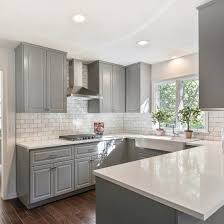Gray Shaker Cabinets White Quartz Counter Tops Grecian White Marble Subway Tile And A Farmhouse Sink Are Sure Timeless Kitchen Kitchen Design Kitchen Remodel