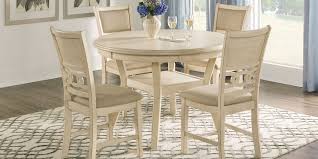This round dining table set is made of mindi and rubberwood solids for added durability, and veneer for style. Round Dining Room Table Sets