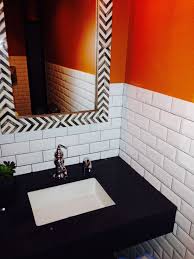 White Subway Tile With Orange Accent Wall And Black Bathroom Counter Black Bathroom Orange Bathrooms Bathroom Decor