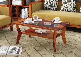 You can go for solid wood bases made of sheesham, and also experiment with treacle carvings for the leg rest, or go for plain. Coffee Center Table Buy Wooden Center Tables Online Latest Center Table Designs