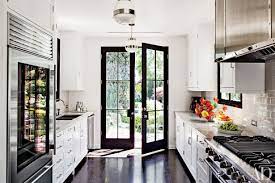 White kitchen cabinets with glass doors and black grid lines. 9 Beautiful Black And White Kitchens From The Ad Archives Architectural Digest