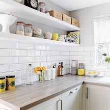 Matt white kitchen cabinets contrasted with strong grey concrete worktops. Howdens Kitchen Worktops
