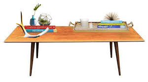 The top of the table is crafted from.5 thick glass for a glossy shine and features gracefully curved edges for added artistry. Modern Eclectic Coffee Table Style Essentials