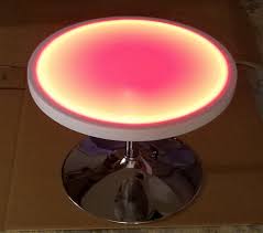 This coffee table contains led strips that light up into various customizable patterns and colors. Portable Light Up Top Round Coffee Table