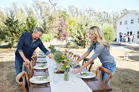 An outdoor party designed to let guests take in the fall color needs a location where leaves are on full display. Mature Couple Setting The Table For A Farm To Table Dinner Party Stock Images Page Everypixel