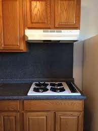 To tile over a backsplash, you could consider covering the old tiles with cement fibre board, and tiling on top of this. How To Cover Up This Blue Laminate Backsplash Hometalk