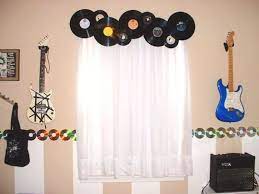 This is a really beautiful and creative music themed bedroom, decorated in a subtle way with a hanging guitar as a decorative element and accordions. Music Themed Home Decor Ideas For Avid Music Lovers