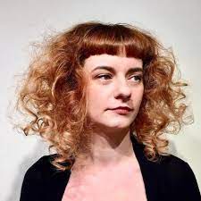 This is also the perfect hair to have straight, blunt bangs because it creates a wonderful contrast to the slight wave at the end of the hair. 40 Cute Styles Featuring Curly Hair With Bangs