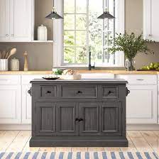 This luxurious white kitchen is highlighted with brass fixtures to accompany it's classic yet contemporary style. Eloy Kitchen Island With Granite Top Reviews Birch Lane