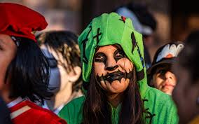 Kids, families, couples trick-or-treat in downtown Lawrence